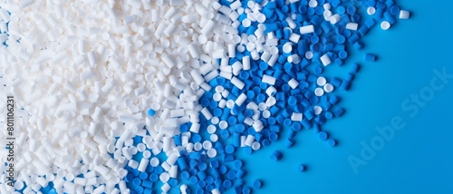 An array of plastic pellets on a vibrant blue background, emphasizing the issue of plastic production waste,