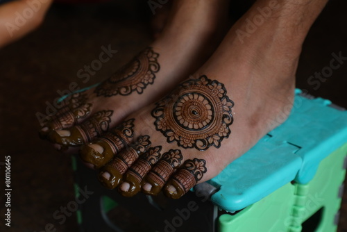 Bangalore, India 9th April 2024: Indian Groom wedding henna mehendi mehndi feet close up. Henna pattern. Traditional Rasam or rivaz of done with henna mehandi. Practiced in India and Pakistan.