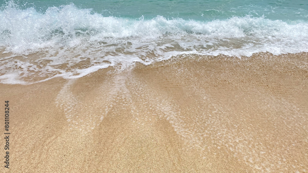a close up of a wave crashing onto a sandy beach. a close up of a wave crashing onto a sandy beach.