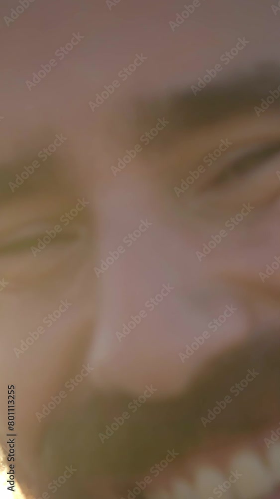 Vertical. Close up of attractive Caucasian man showing wide smile to camera. Young male outdoors with positive and relaxed attitude enjoying vacation. Joyful millennial tourist people on sunny day Vertical. Close up of attractive Caucasian man showing wide smile to camera. Young male outdoors with positive and relaxed attitude enjoying vacation. Joyful millennial tourist people on sunny day