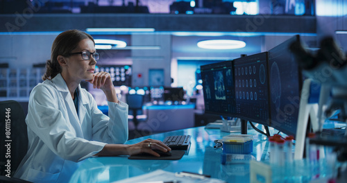 Hospital Research Laboratory: Female Medical Scientist Using Computer with Brain Scan MRI Images. Professional Neurologist Analysing CT Scan, Finding Treatment Solutions for Patient With Brain Damage.