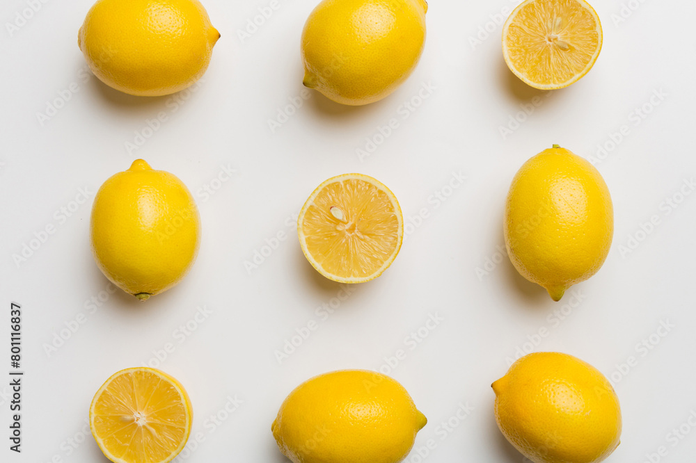 Many fresh ripe lemons as colored background, top view. Elegant background of lemon and lemon slices Top view flat lay
