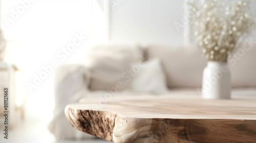 A wooden table top made of sawn wood in the interior of the room on the background of a sofa