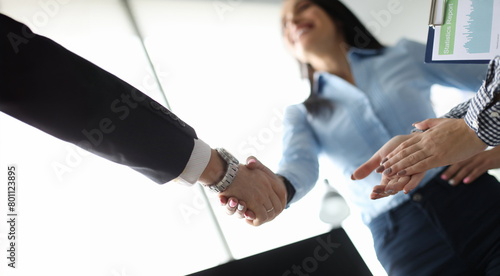 Businesswoman and businessman shake hand in ofiice. Business sign contract concept photo