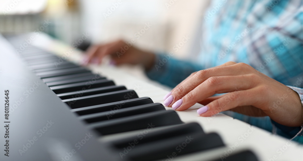 Close-up of female hands playing synthesizer in music workshop. Professional cute pianist creating new musical composition. Art concept. Blurred background Close-up of female hands playing synthesizer in music workshop. Professional cute pianist creating new musical composition. Art concept. Blurred background