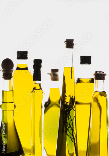set of different types of oil bottles backlit photo