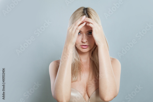 Beautiful woman hiding her face her hands on white background © artmim