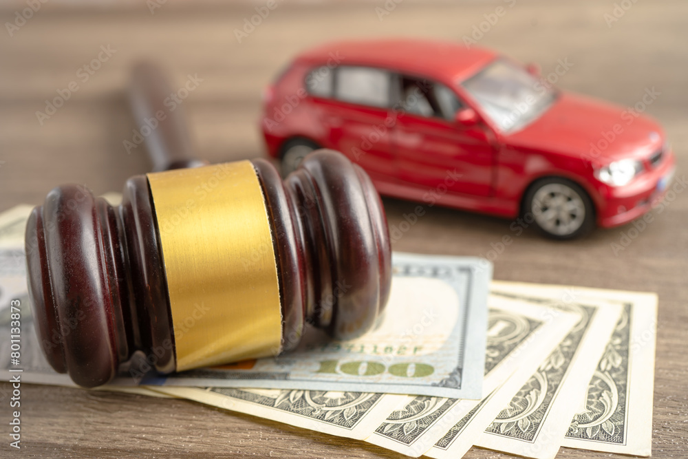 Hammer gavel judge and US dollar banknote money with car vehicle accident, insurance coverage claim lawsuit court case.