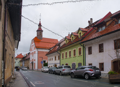 The historic Spodnji Trg Street in Skofja Loka in Gorenjska, Slovenia. Zalostna Mati Bozja v Spitalski Cerkvi - the Sorrowful Mother of God in Spital church - can be seen centre left