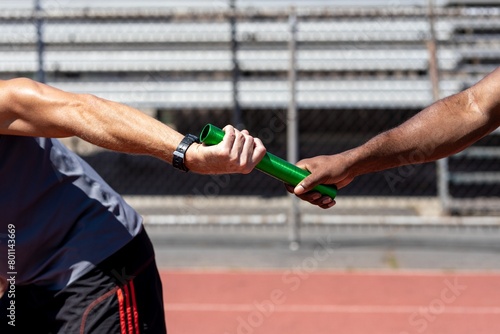 Fototapeta Naklejka Na Ścianę i Meble -  Team mates passing a relay baton