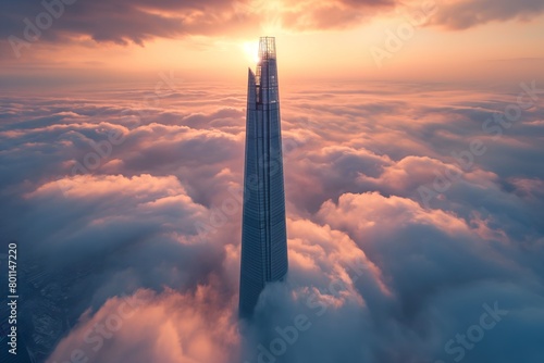 Lone tall skyscraper over the clouds at sunrise, beautiful view photo