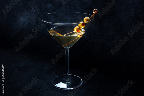 Martini. A glass of dirty martini cocktail with vermouth and olives, with a place for text