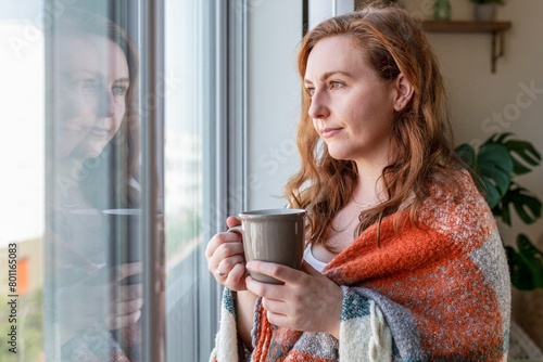 Sad lonely woman staring out the window
