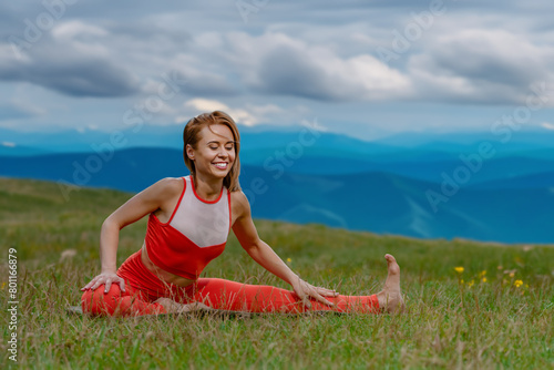Portrait of cheerful smiling sporty girl doing yoga fitness exercise outdoor in beautiful mountains landscape, Elevated fitness: Young woman embraces a mountain workout for holistic summer health