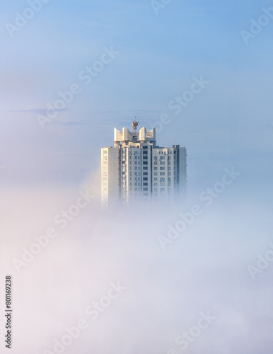 Skyscraper of Kyiv in the background of morning fog and dust from Africa