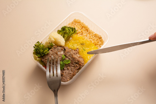 Meat packed lunch box home prepared meal in aerial top view close up empty space isolated