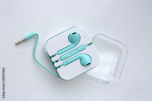 Headphones-headset. Headphones for listening to music and sound on portable devices: music player, smartphone, laptop on a white background. Flat lay top view copy space. Minimal style. Music concept.