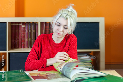 Concentrated student reading books in library