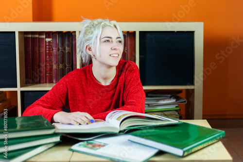 Pensive student contemplating in a library.