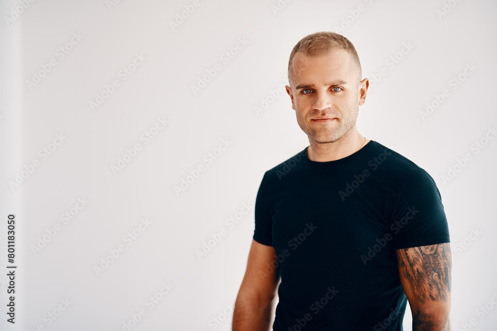Handsome young man looking to camera over soft white background Handsome young man looking to camera over soft white background
