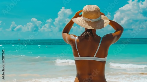 Person applying sunscreen on their back at the beach concept of skin care and UV protection 