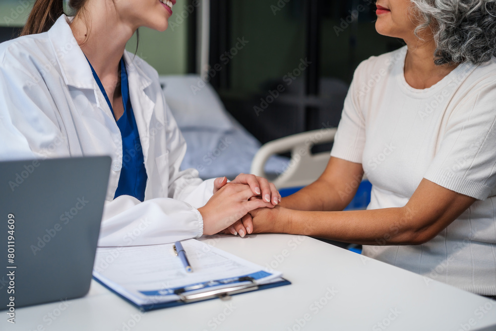 Obraz premium Monthly health check-ups and counseling sessions are provided to an elderly Asian woman by a Caucasian female caregiver, offering support, advice, and motivation.