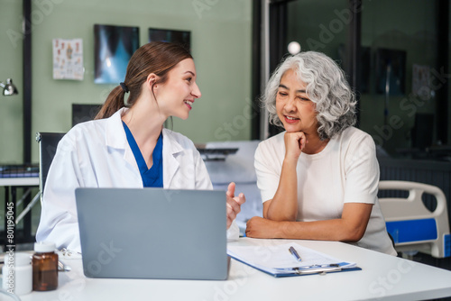 Wallpaper Mural Monthly health check-ups and counseling sessions are provided to an elderly Asian woman by a Caucasian female caregiver, offering support, advice, and motivation. Torontodigital.ca