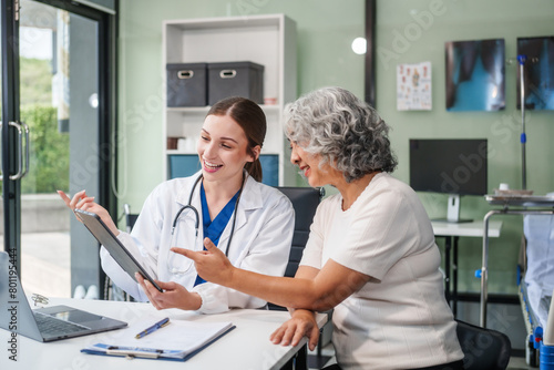 Wallpaper Mural Monthly health check-ups and counseling sessions are provided to an elderly Asian woman by a Caucasian female caregiver, offering support, advice, and motivation. Torontodigital.ca