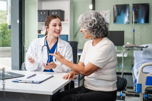 Monthly health check-ups and counseling sessions are provided to an elderly Asian woman by a Caucasian female caregiver  offering support  advice  and motivation.