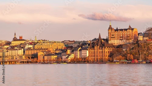 Time lapse of Slussen in Stockholm, Sweden, with a view of Mariahissen on the island of Södermalm. Early spring, late evening sun, clouds passing by. photo