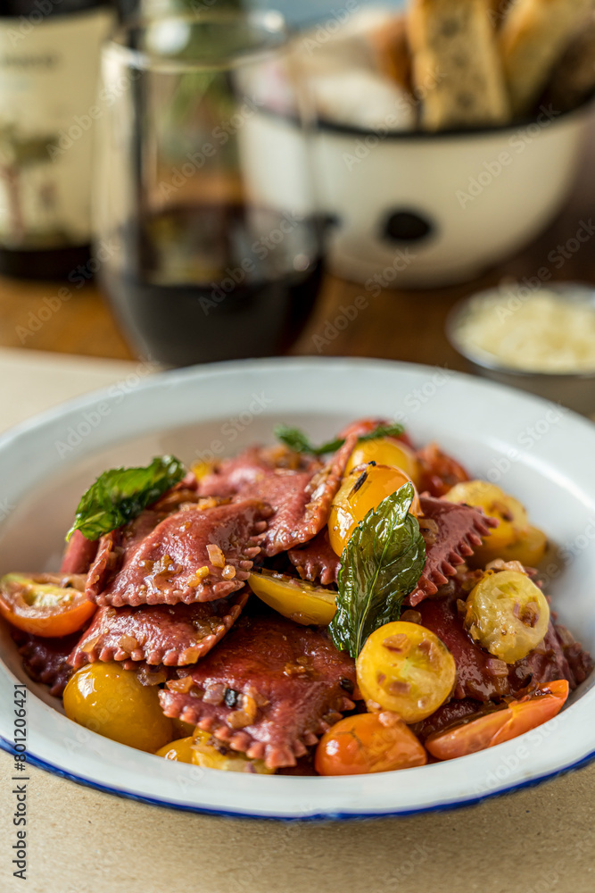 Beet ravioli with cherry tomatoes and basil ready to eat Beet ravioli with cherry tomatoes and basil ready to eat
