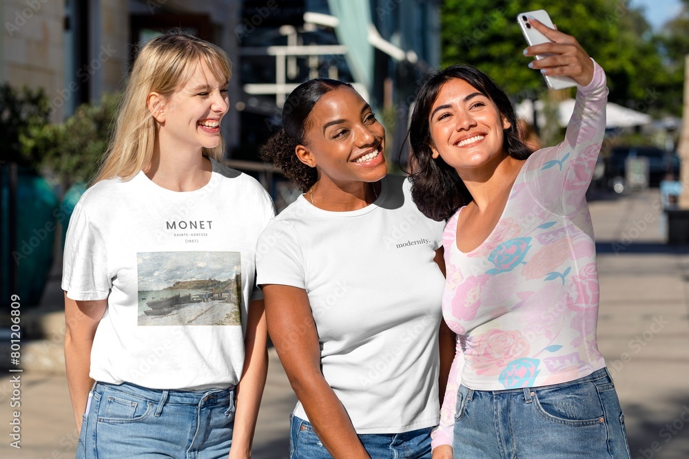 Three girlfriends taking a selfie, hanging out in the city Three girlfriends taking a selfie, hanging out in the city