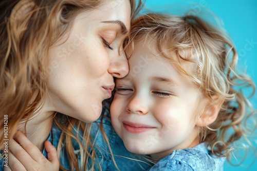 Mother kissing her daughter's face, Mother's Day concept.
