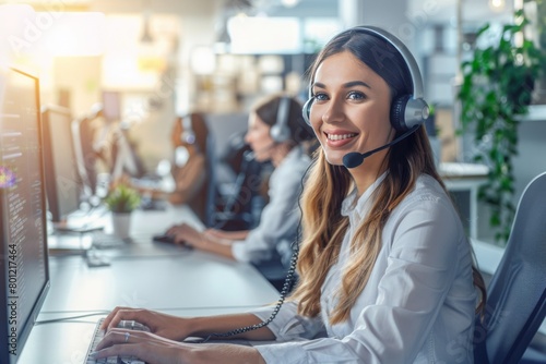 Woman as a customer service wearing a headset and talking on a phone while sitting in front of a computer. photo