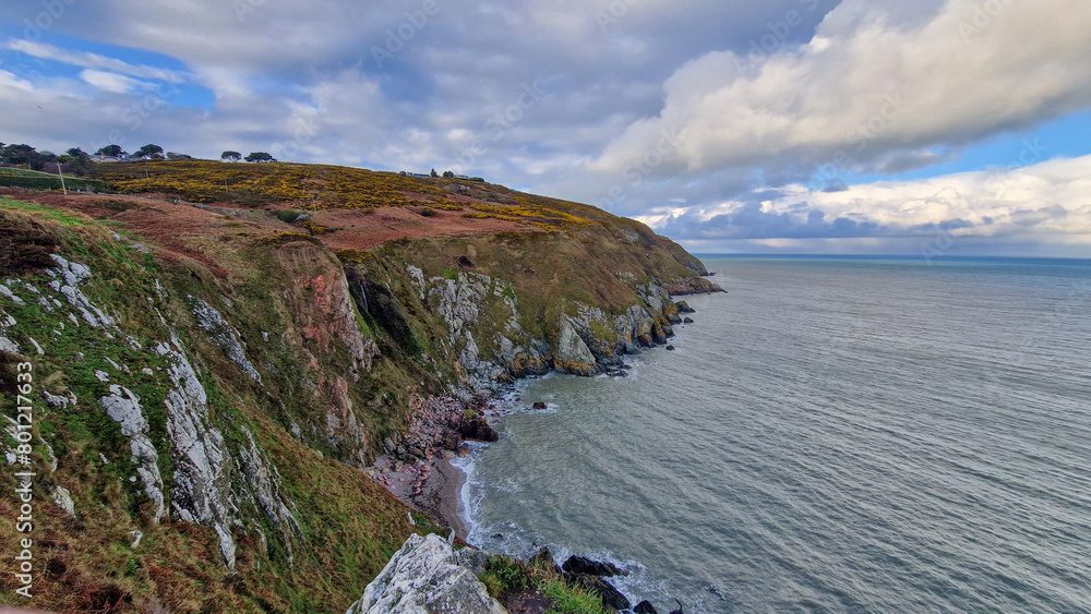 Traversing Howth's rugged paths unveils a panoramic spectacle: Dublin Bay, a shimmering jewel set against the city's skyline, beckons adventurers to savor the beauty of Ireland's coast. 