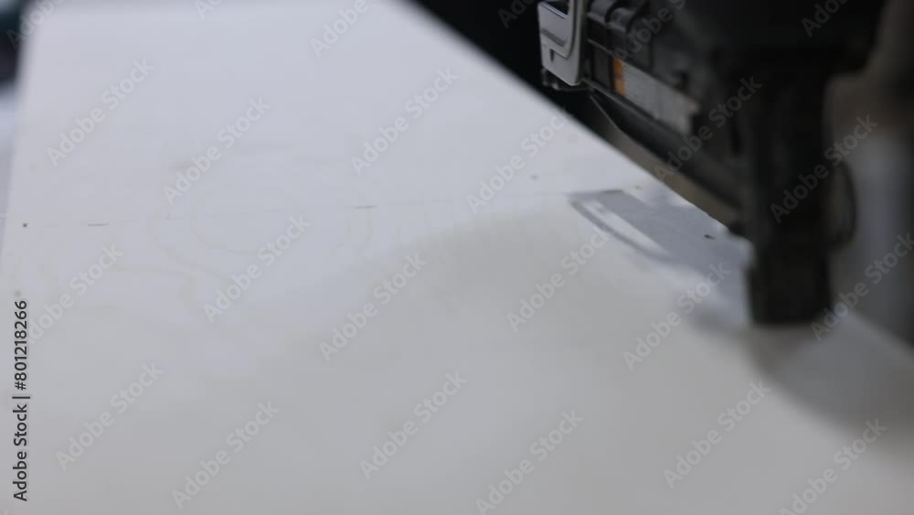 A carpenter fastens wooden parts with pneumatic stapler staples, close-up. Worker making sofa in furniture factory A carpenter fastens wooden parts with pneumatic stapler staples, close-up. Worker making sofa in furniture factory
