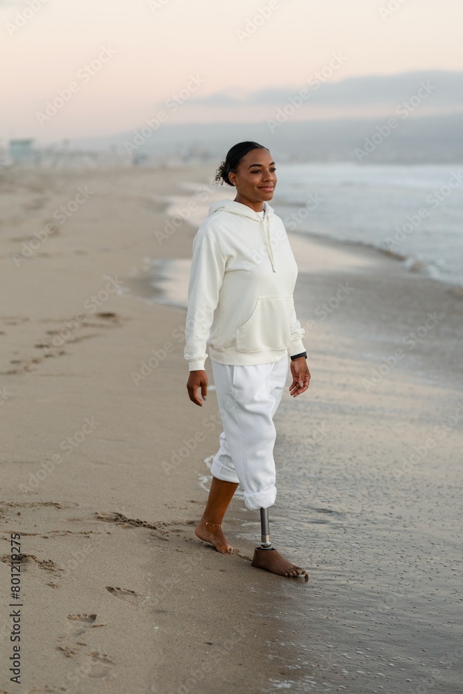 Happy disabled woman smiling, walking by the beach Happy disabled woman smiling, walking by the beach