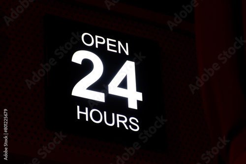 Open 24 Hour neon sign in the street. photo