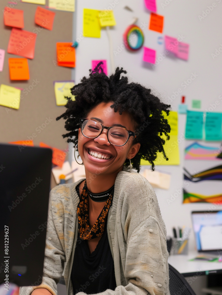 Smiling african american girl at her workplace, working hard in the office at her desk. Pleasant working atmosphere Smiling african american girl at her workplace, working hard in the office at her desk. Pleasant working atmosphere