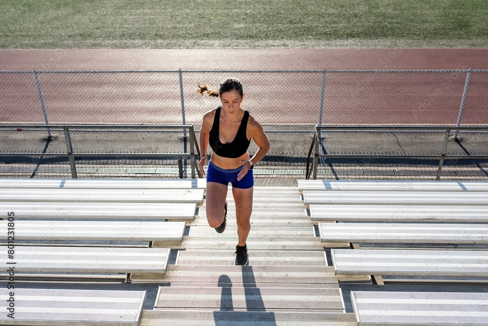 Obraz premium Woman running up stairs for a workout