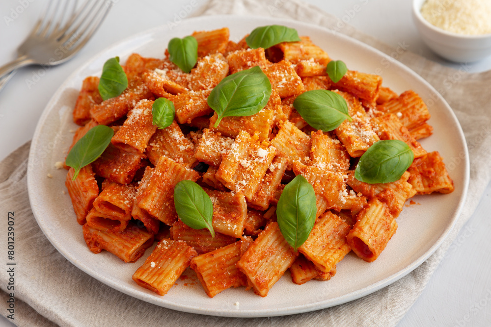 Homemade Vodka Rigatoni Pasta with Parmesan Cheese and Basil, side view. Homemade Vodka Rigatoni Pasta with Parmesan Cheese and Basil, side view.