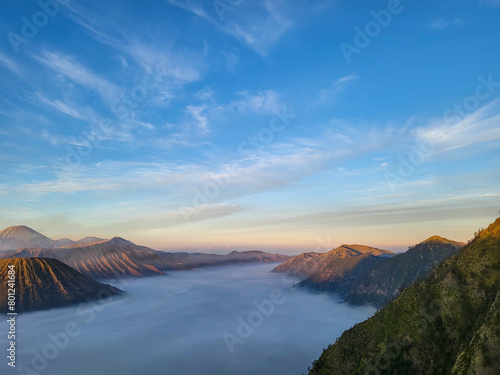 Sunrise view from Penanjakan 2 or Seruni point below can be seen the fog still covers the sea of sand and on the right side of the batok mountain. Beautiful Nature background and wallpaper. photo