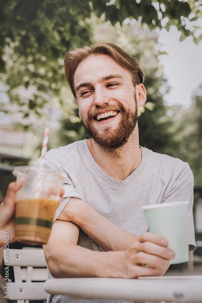 Man talking to a friend while having coffee Man talking to a friend while having coffee