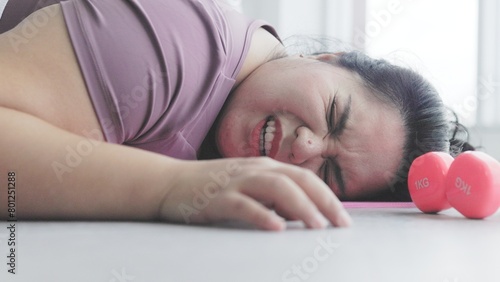 chubby asian woman is tired from heavy exercise
