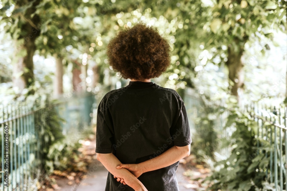 Woman walking in a park, rear view Woman walking in a park, rear view