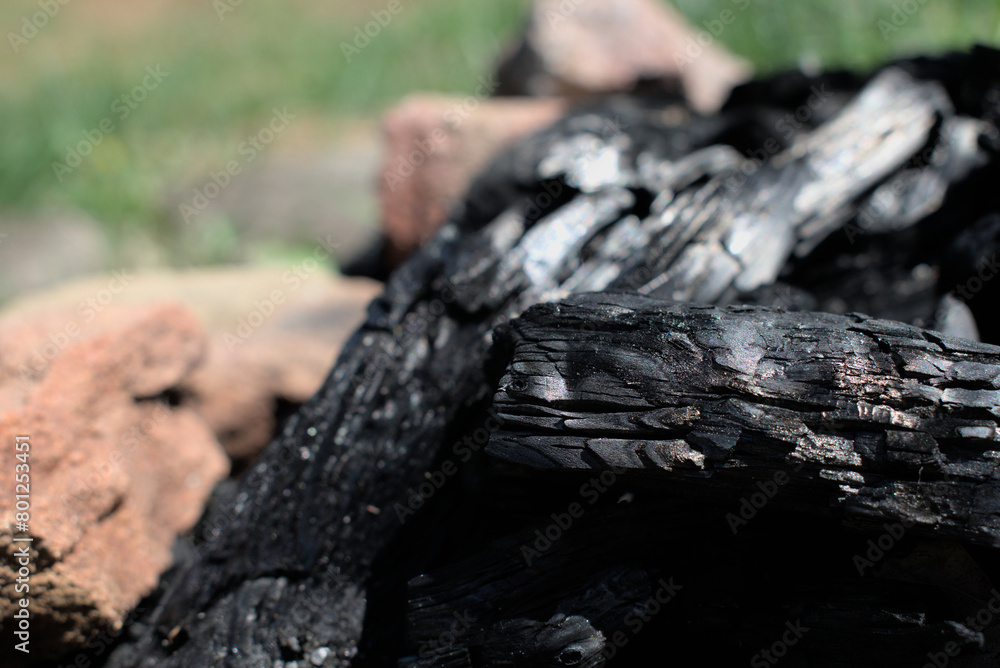 Close up of charcoal in a fire pit in a field Close up of charcoal in a fire pit in a field