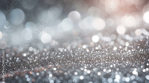 Silver glitter background with shiny lights. Defocused silver and pink lights.