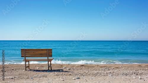 Solitary beach chair facing the serene blue ocean on a pebbly shore  inviting a moment of peace and relaxation