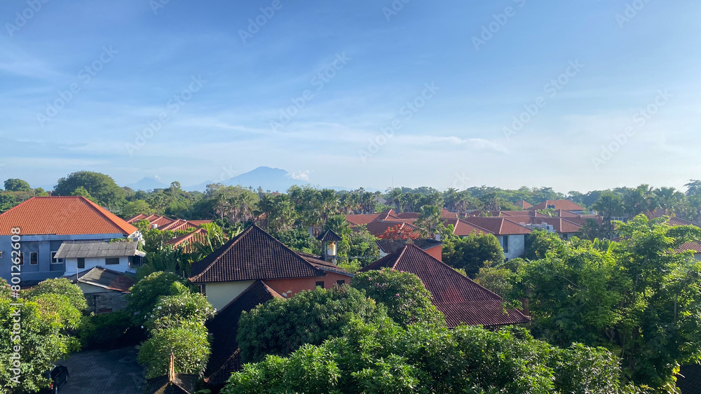 a view of a village in bali with a mountain in the background