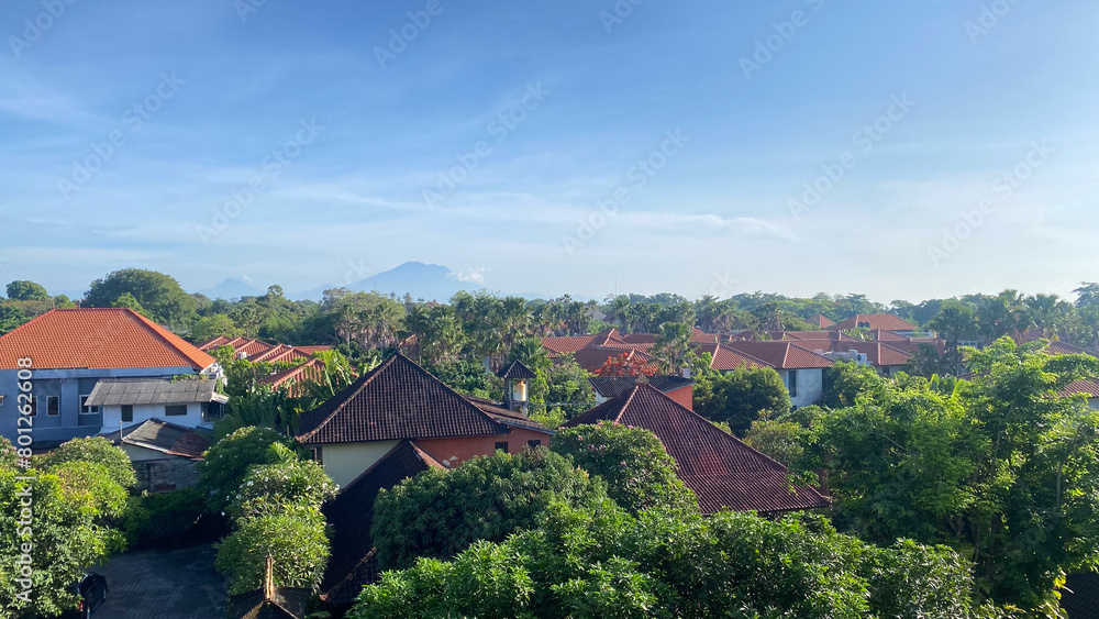 a view of a village in bali with a mountain in the background a view of a village in bali with a mountain in the background